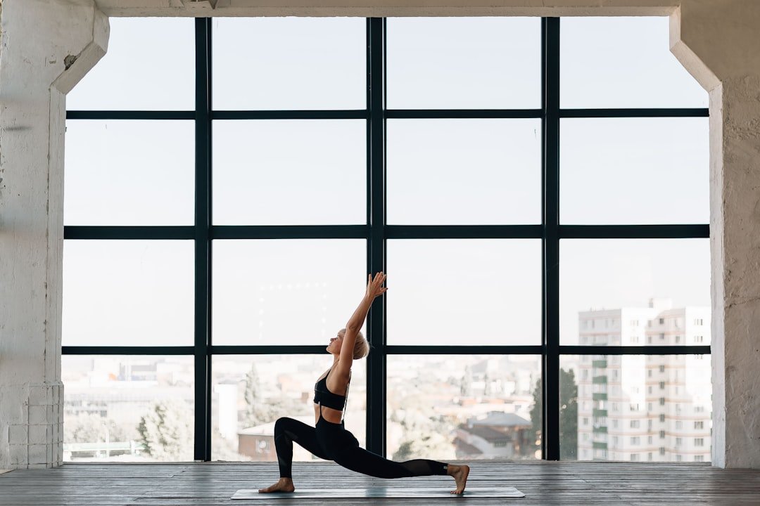 A serene yoga scene with a person practicing simple poses in a peaceful environment, showcasing strength and relaxation.