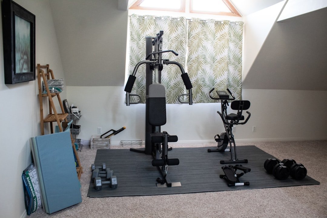 A small home gym setup featuring versatile exercise equipment like dumbbells, resistance bands, and a yoga mat in a cozy living space.