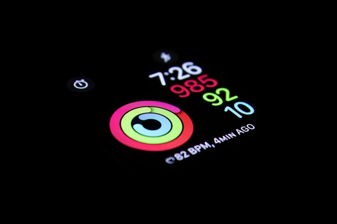 A person using a fitness tracker while exercising outdoors, looking focused and motivated.